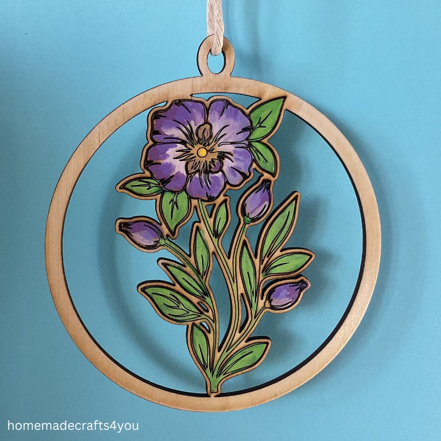 Hanging wooden decoration of a purple flower with buds