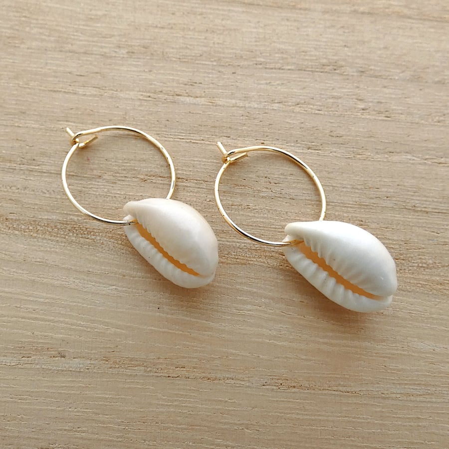 Gold plated 15mm hoop earrings with cowrie shell charms.  Ref: 324