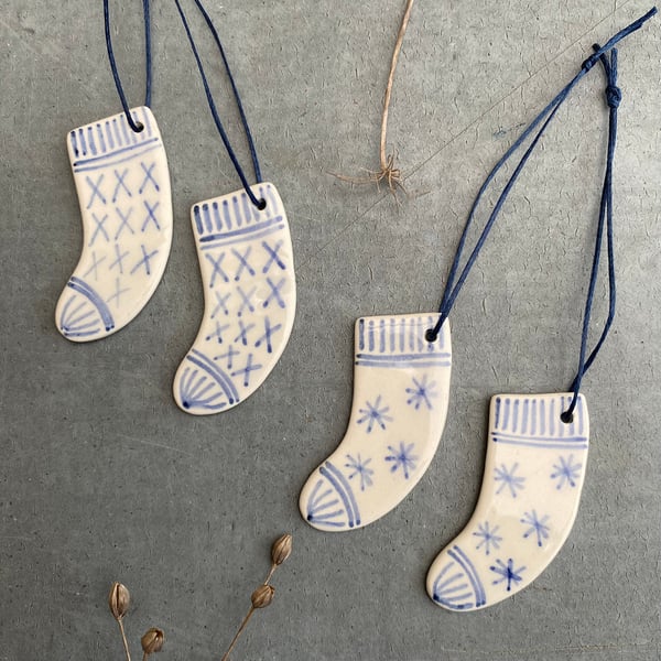 Set of four ceramic sock decorations .