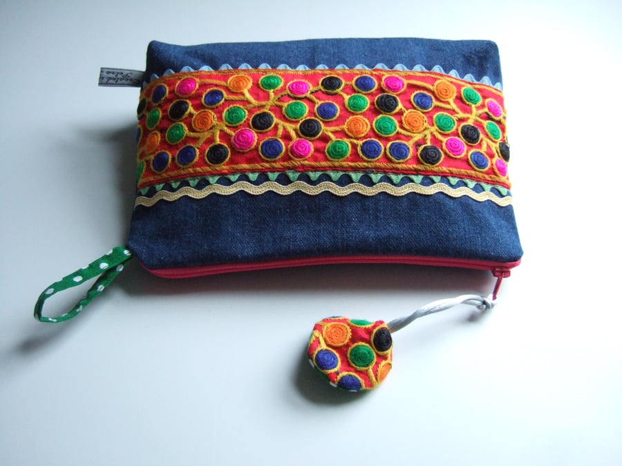 Bright orange embroidered braid and denim toiletries, make up, or storage bag.