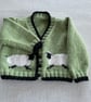 Green baby cardigan with sheep designs on the front - Image 1