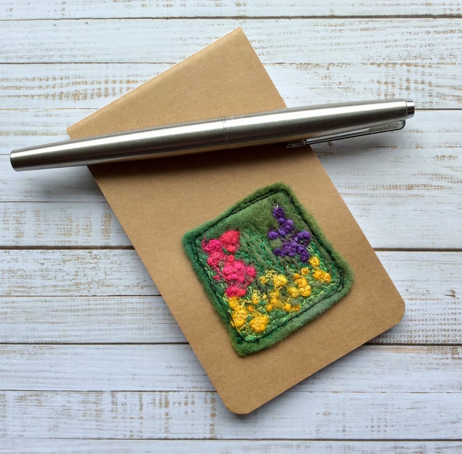 Pocket embroidered flower notepad. 