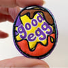 Up-cycled embroidered chocolate egg brooch pin or badge. 