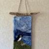 Handmade Needle Felted Wall Hanging. Puffin looking out to sea from the cliff to