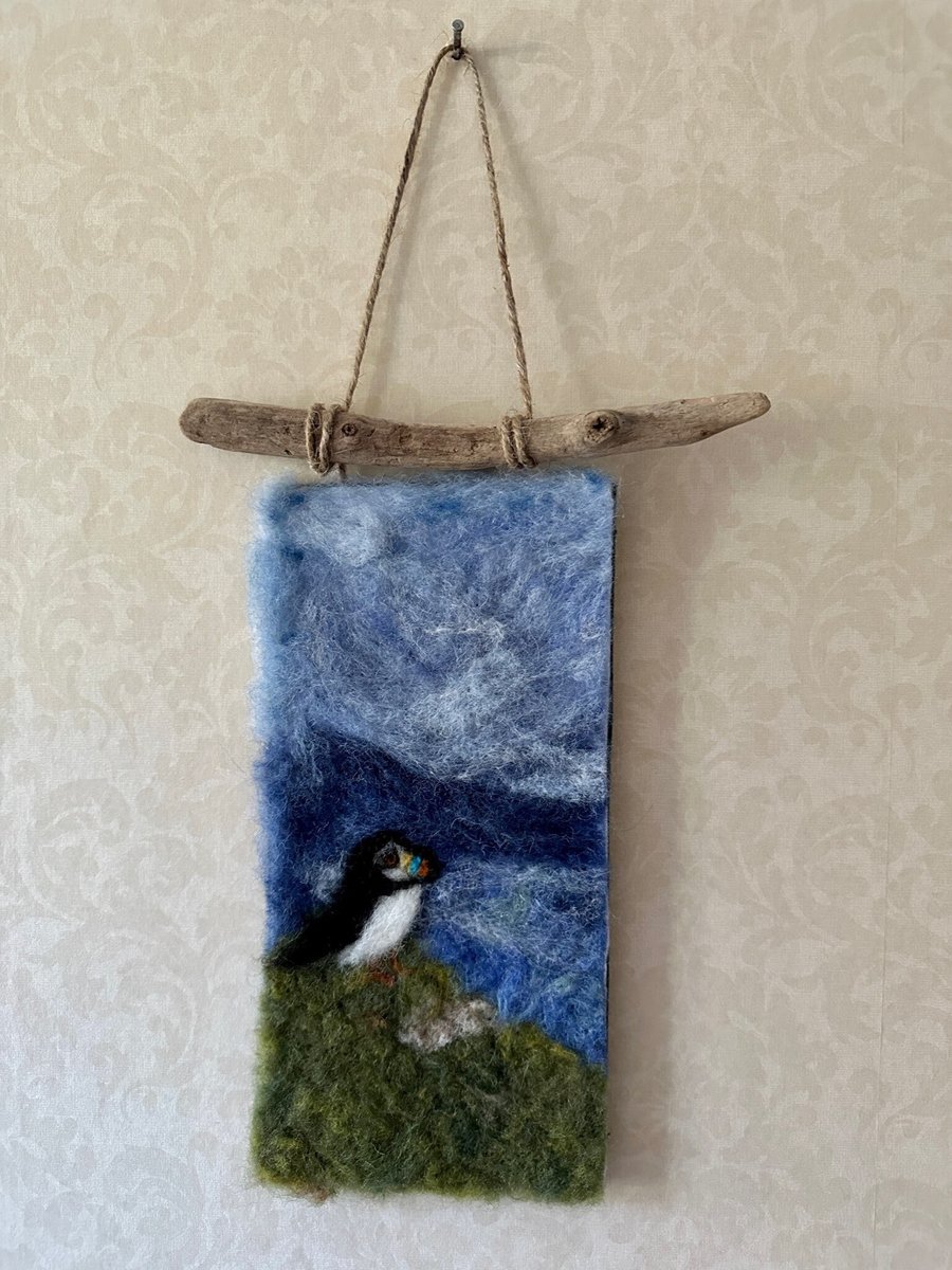 Handmade Needle Felted Wall Hanging. Puffin looking out to sea from the cliff 