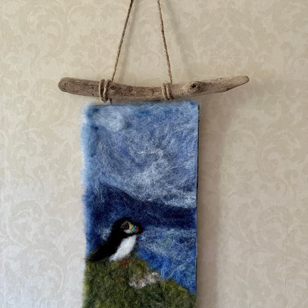 Handmade Needle Felted Wall Hanging. Puffin looking out to sea from the cliff 
