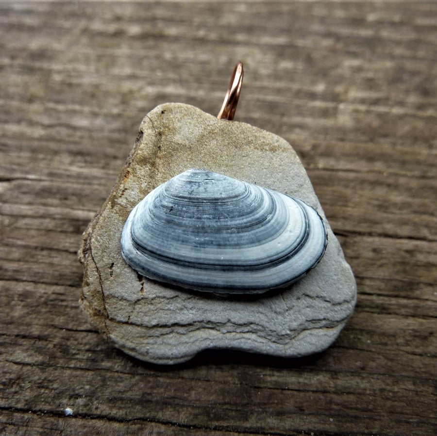 Pendant - blue and white striped sea shell on sand coloured beach pebble