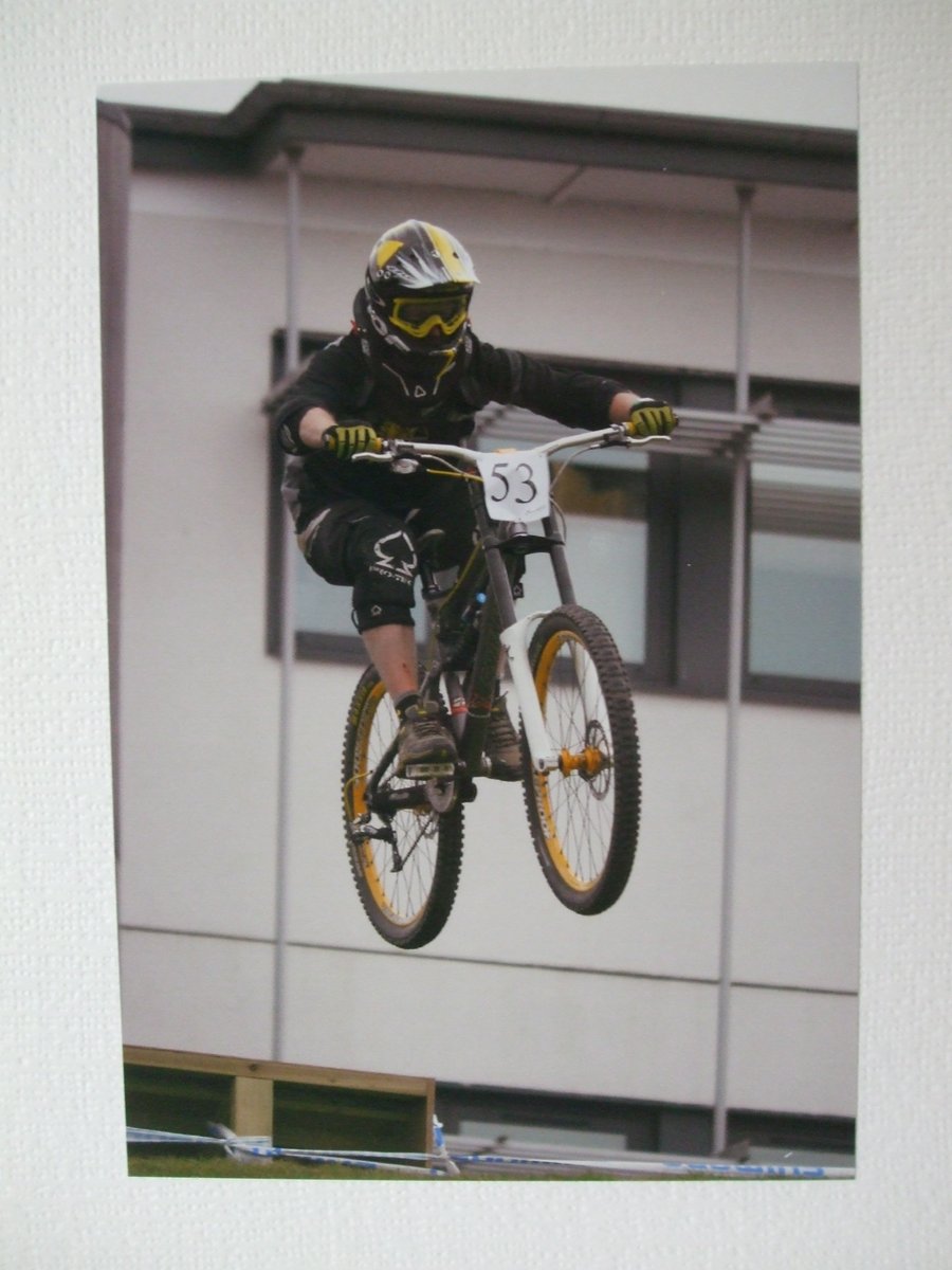 Photographic greetings card of a downhill bike racer, number 53.