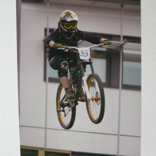 Photographic greetings card of a downhill bike racer, number 53.