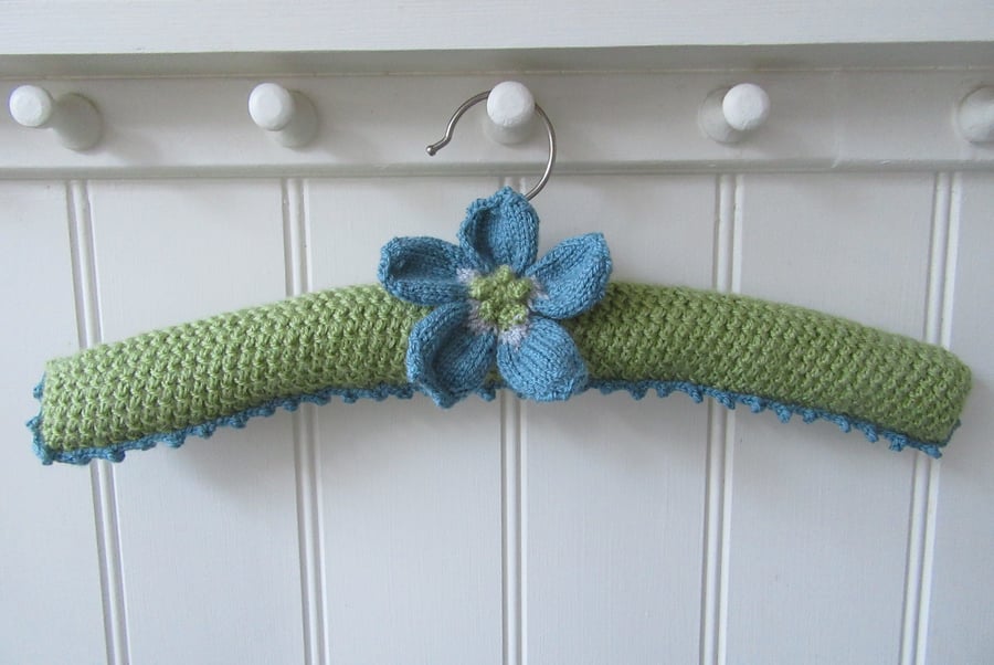 Hand knitted padded coat hanger with knitted anemone flower