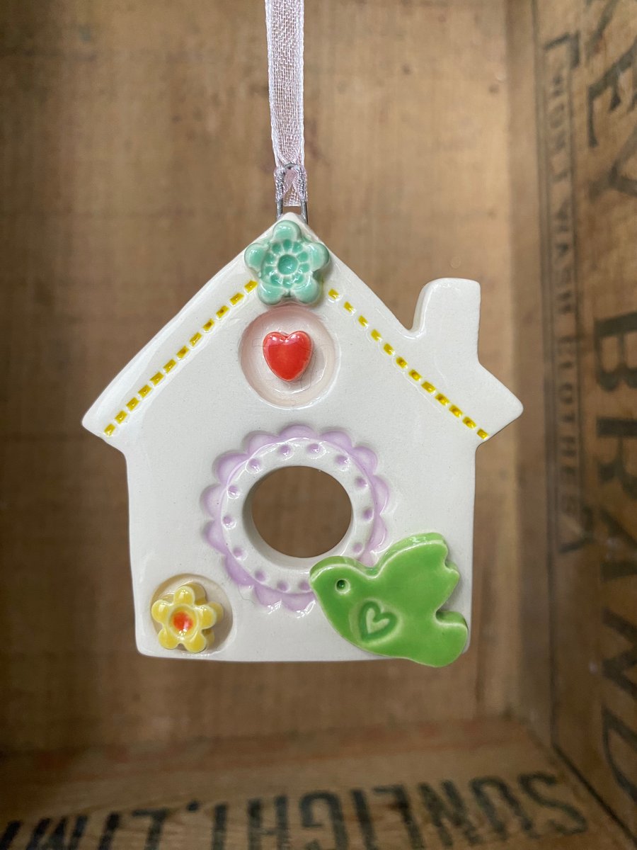 Small Ceramic bird house decoration with small green bird
