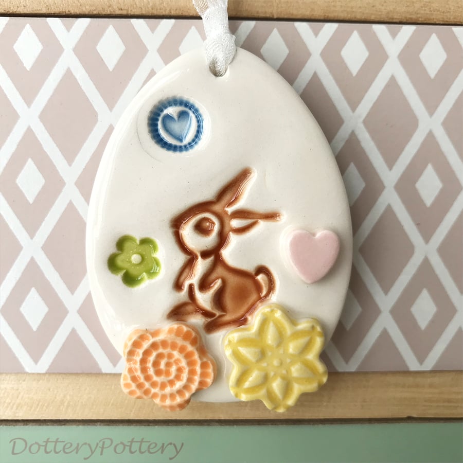 Pottery Easter Egg decoration with bunny in the flower meadow 