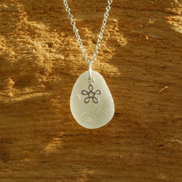 Sea glass pendant with tiny silver flower charm