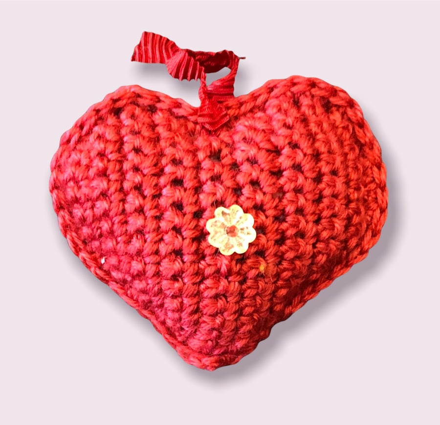 Hanging padded red heart with costume beads and pearls.