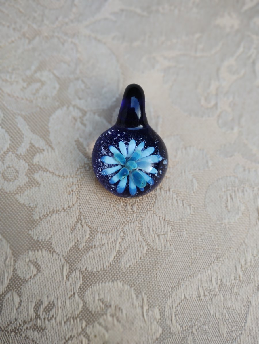 Small blue sparkly flower implosion pendant