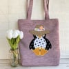 Penguin tote bag in lilac with a floral penguin in a straw sunhat