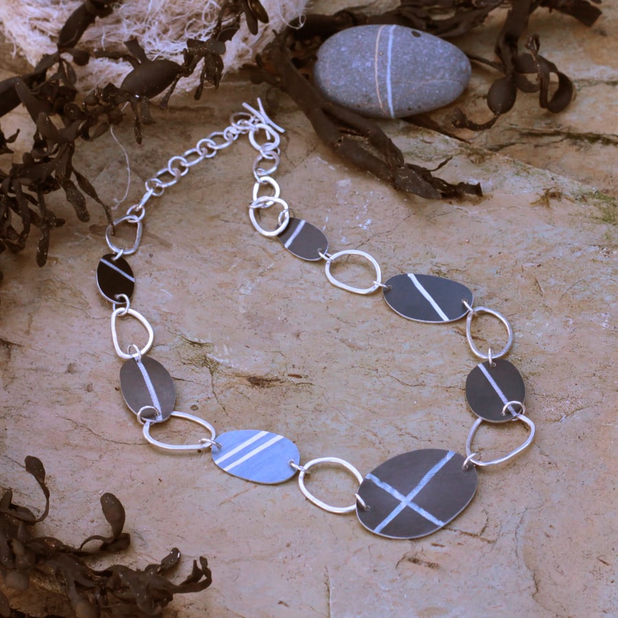 Reversible pebble necklace, anodised aluminium and recycled silver.