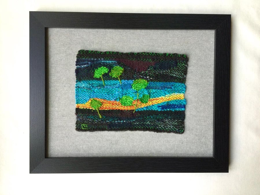 Framed handwoven tapestry weaving, textile in green, yellow, turquoise and black