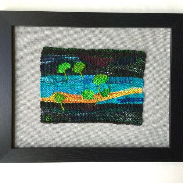 Framed handwoven tapestry weaving, textile in green, yellow, turquoise and black