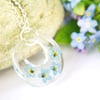 botanical terrarium necklace with real forget me not flowers for nature lovers