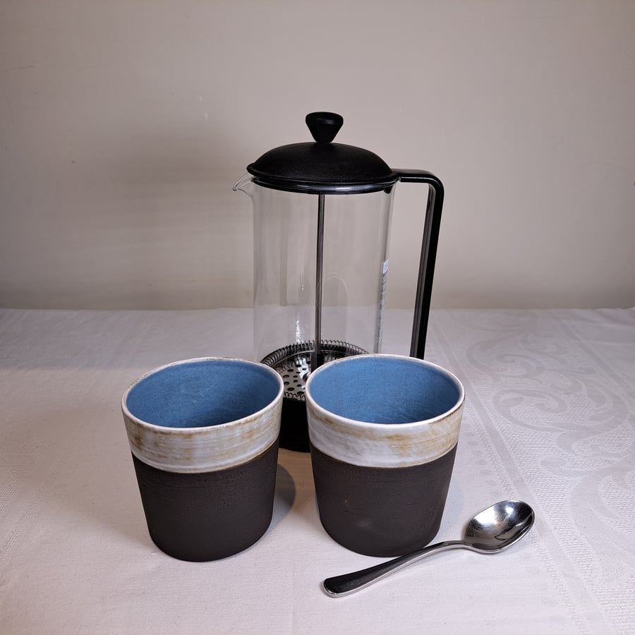Small blue and white ceramic coffee beaker tumbler mug