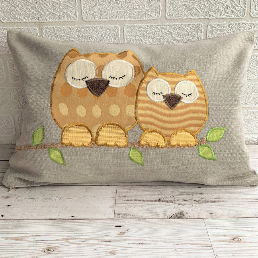 Sleepy owls cushion with gold coloured owls on a pale taupe cushion