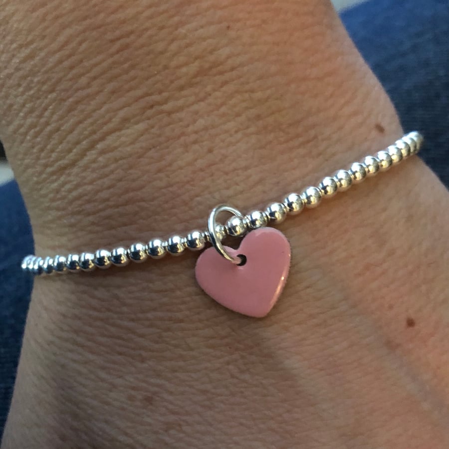 Pale pink enamel heart on silver beaded stretch bracelet. Stacking bracelet.