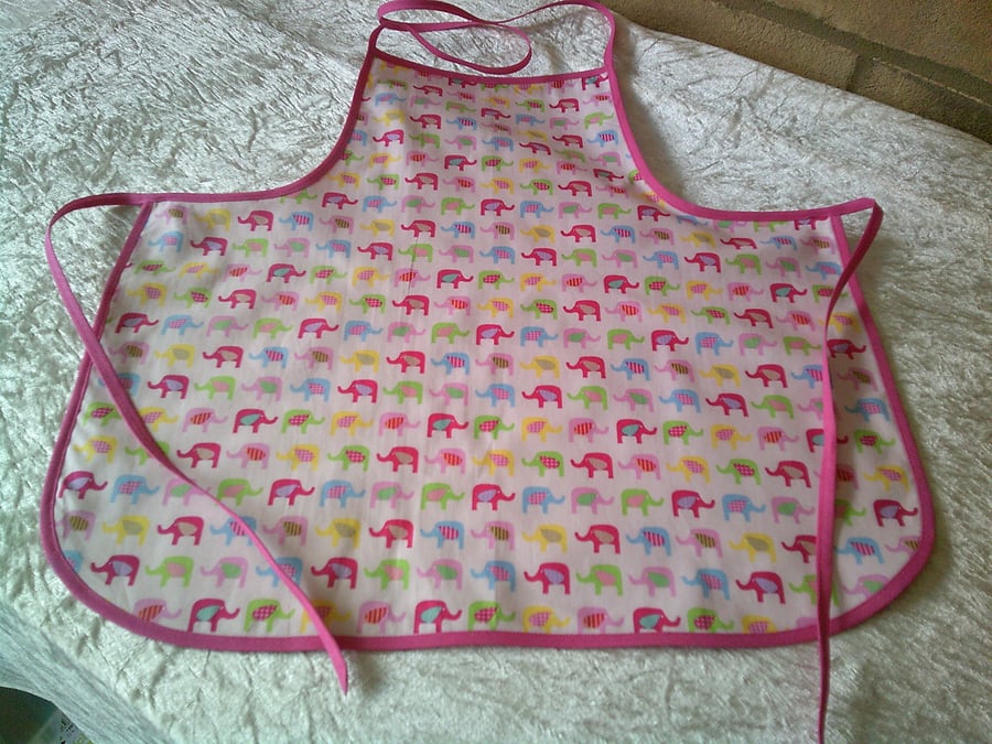 Baby Apron with Multi Coloured Elephants on a Pink background