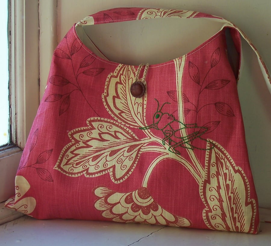 Floral fabric shoulder bag with embroidered grasshopper
