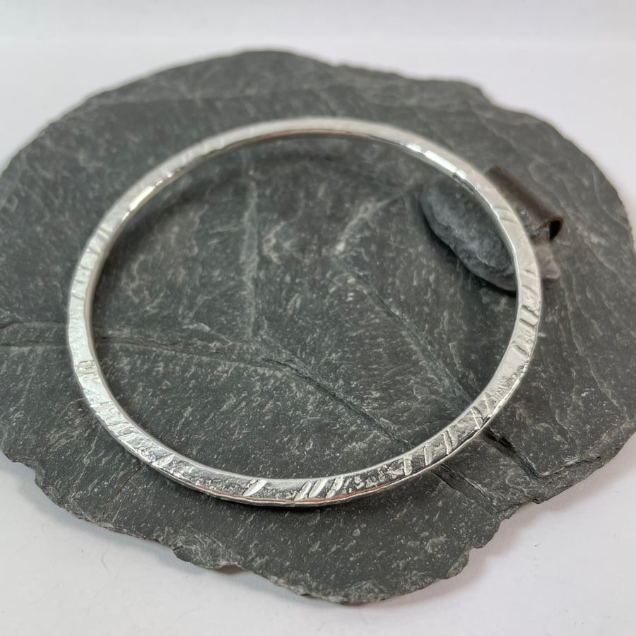 Round Sterling silver bangle with beaten texture