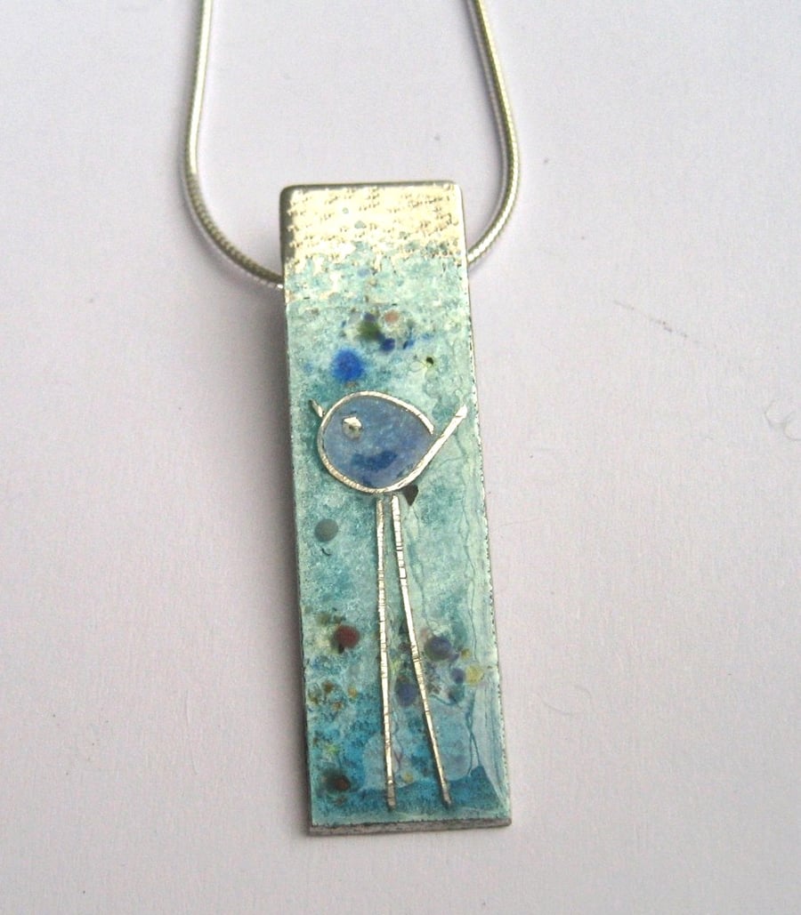 Enamelled sterling silver necklace with little bluebird with long legs.