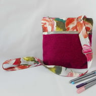 Fabric crossbody bag with zipped pocket on front in bright magenta