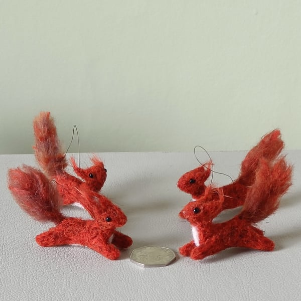 Wee red squirrels leaping -dark red