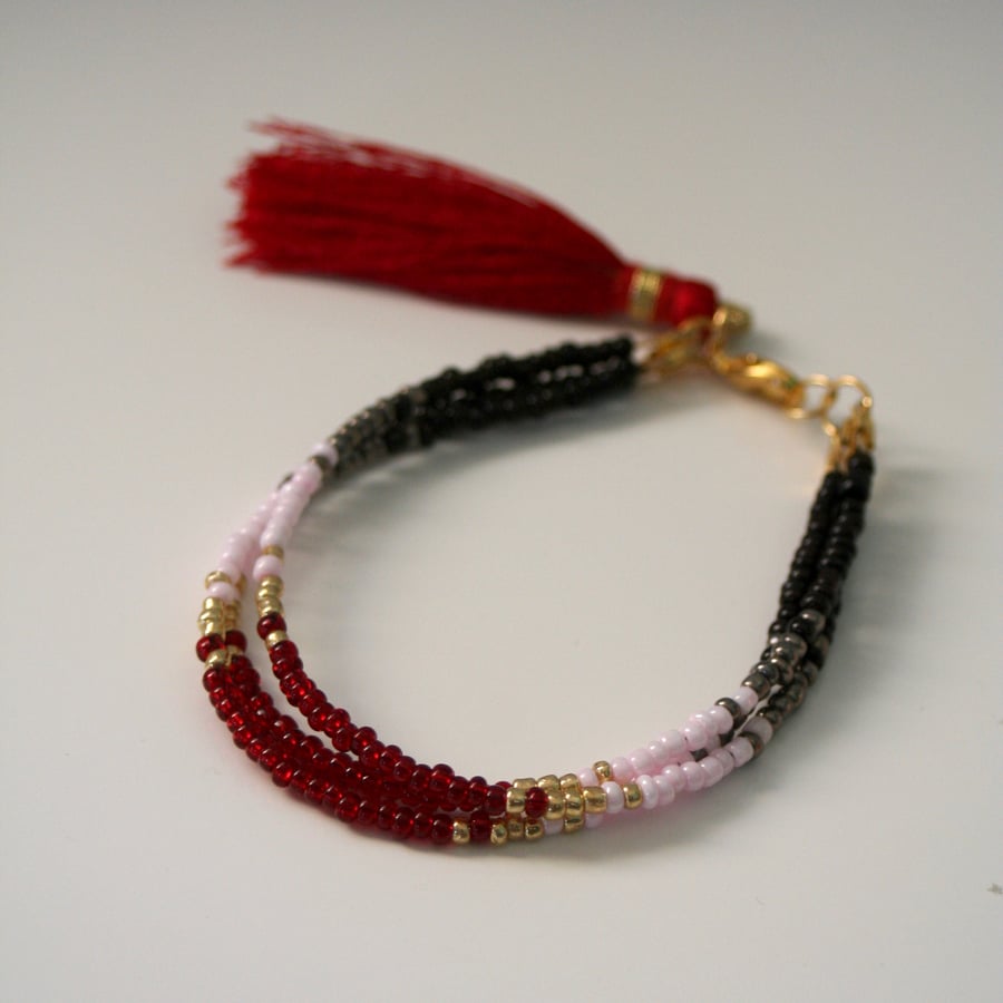 Multi-strand beaded tassel bracelet, red and black