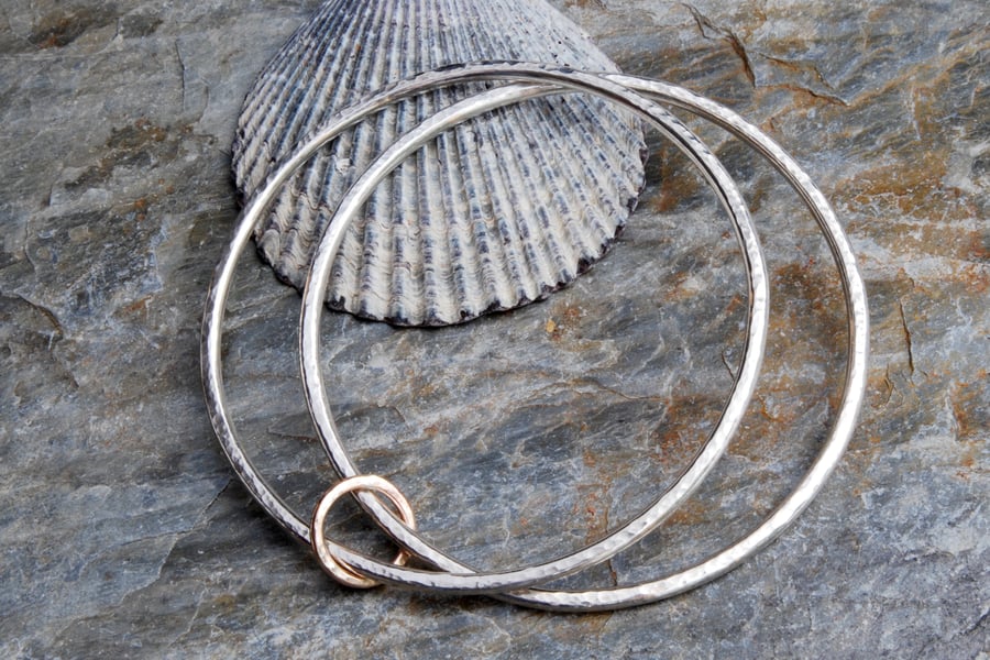 Sterling silver and 9 carat gold linked hammered bangles