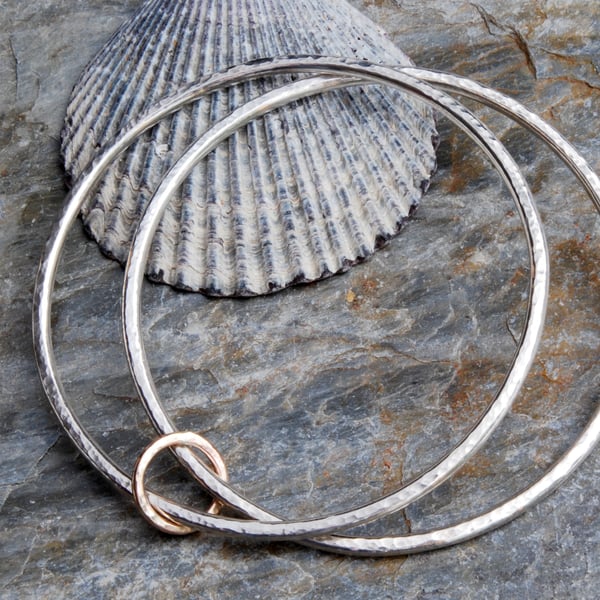Sterling silver and 9 carat gold linked hammered bangles