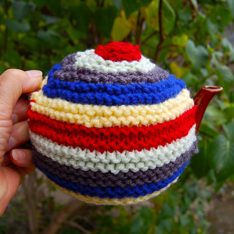 Colourful stiped tea cosy.  For a small one cup teapot