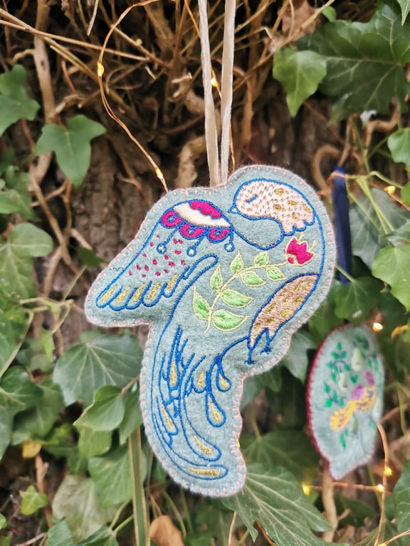 Embroidered modern folk bird on felt fabric. With a hanging ribbon, a lovely Chr