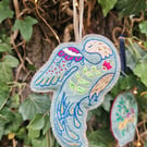 Embroidered modern folk bird on felt fabric. With a hanging ribbon, a lovely Chr