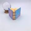 Blue and pink hand marbled mini coptic stitch notebook