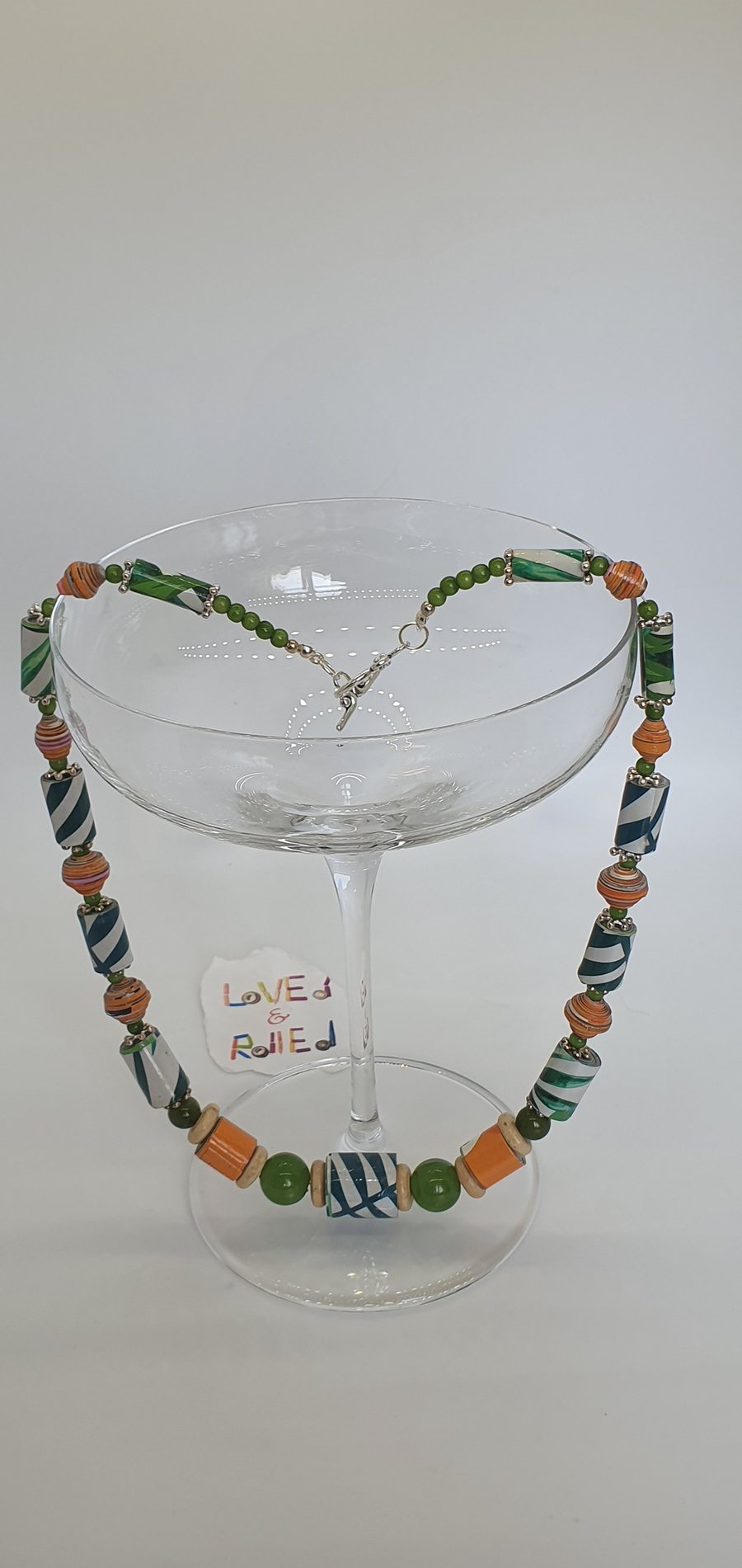 Green foliage paper beaded necklace with orange contrasting beads