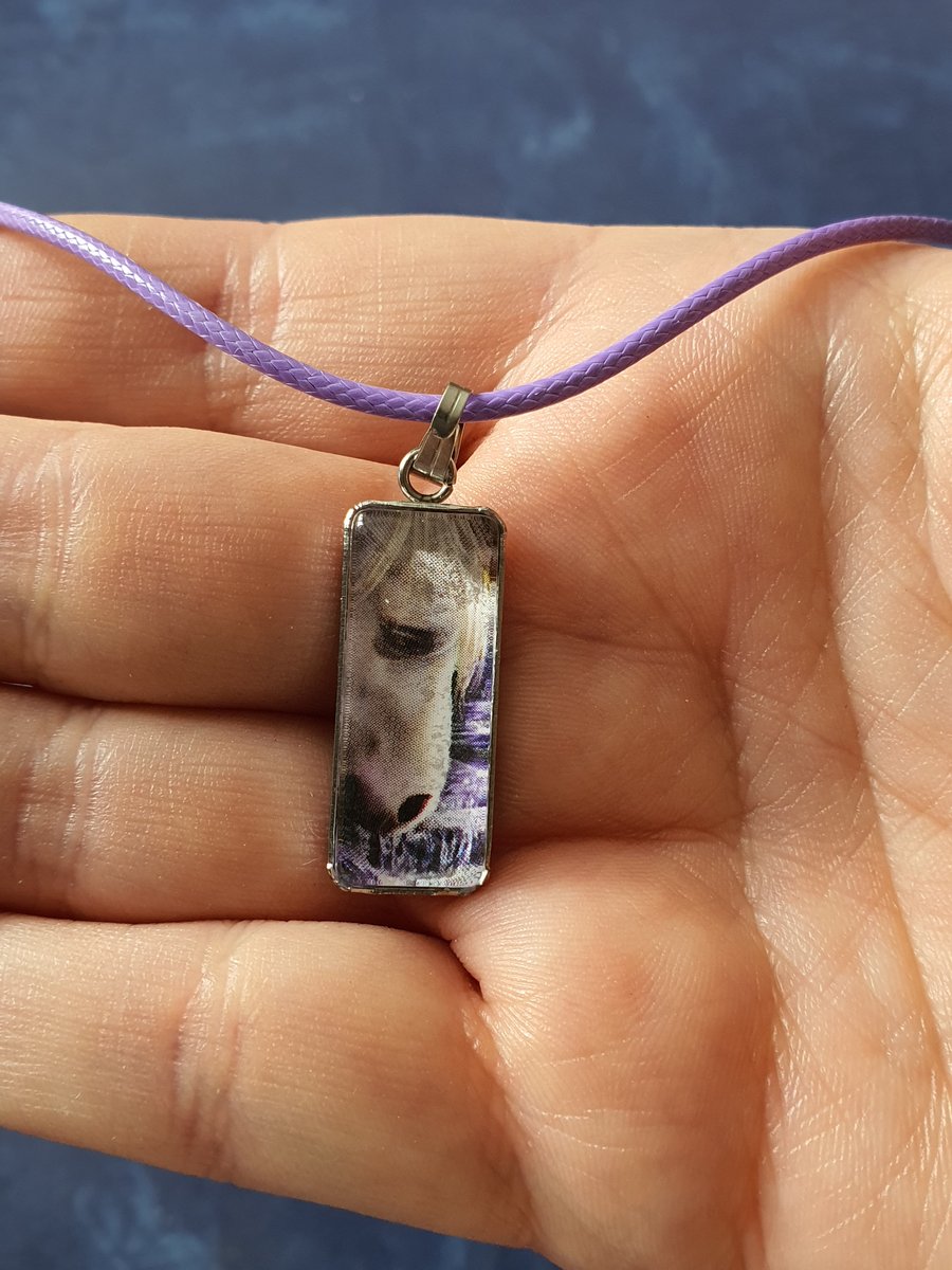 Purple necklace with a horse face in a glass cabochon