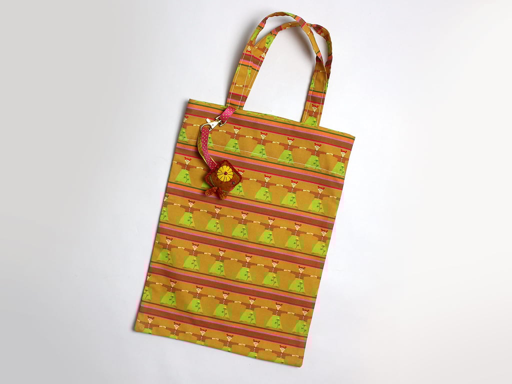 Dolly print tote bag with hand embroidered bag charm