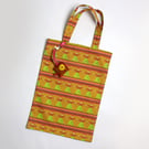 Dolly print tote bag with hand embroidered bag charm