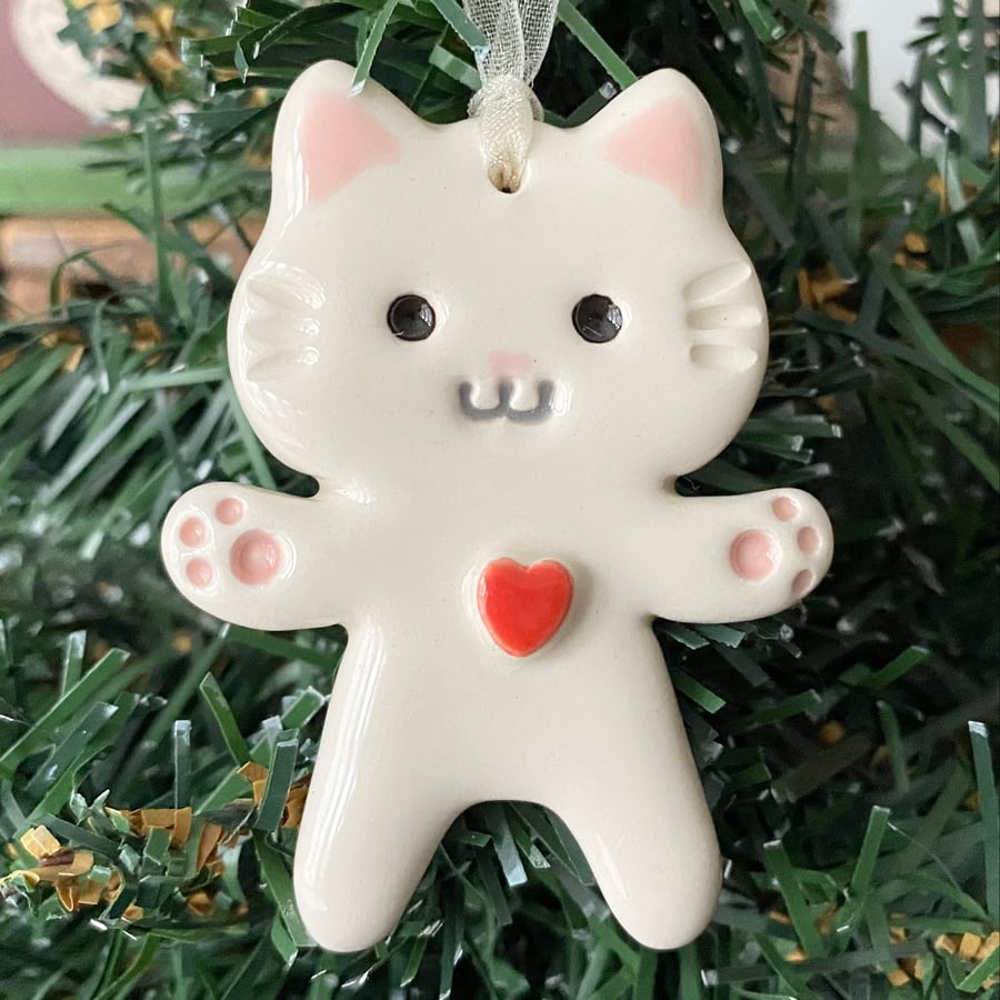 Small white pottery cat decoration with red heart