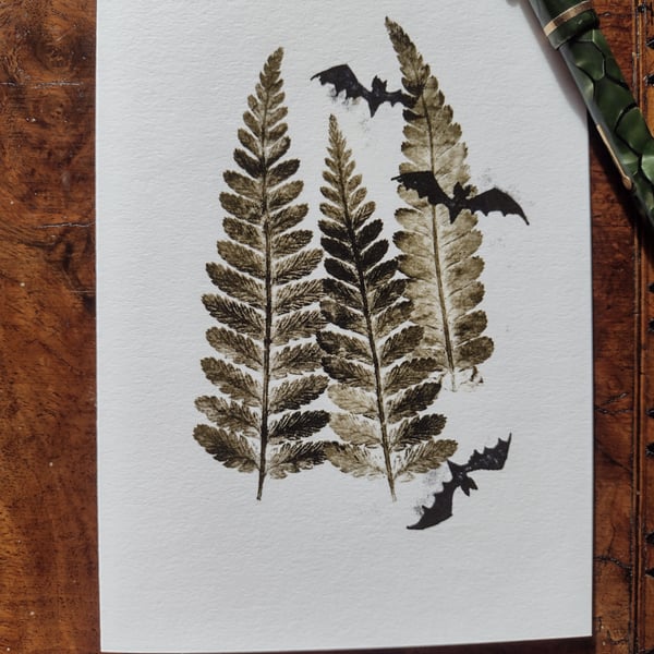 Bats in trees. Image made on a printing press and hand made stamps.