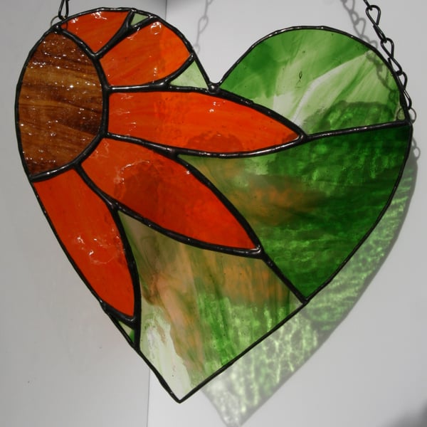 Stained Glass hanging heart with orange flower with green background suncatcher