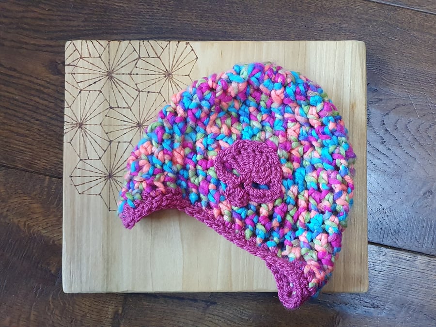 Child's rainbow beanie hat with ear flaps and skull motif