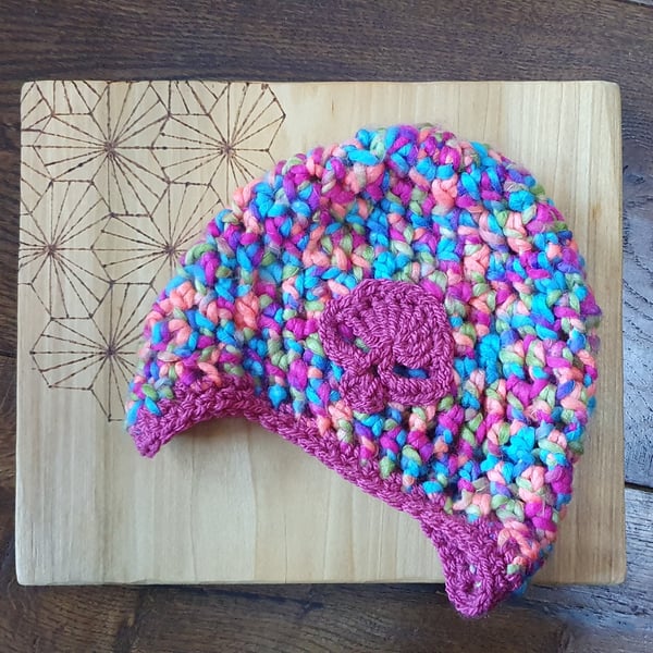Child's rainbow beanie hat with ear flaps and skull motif
