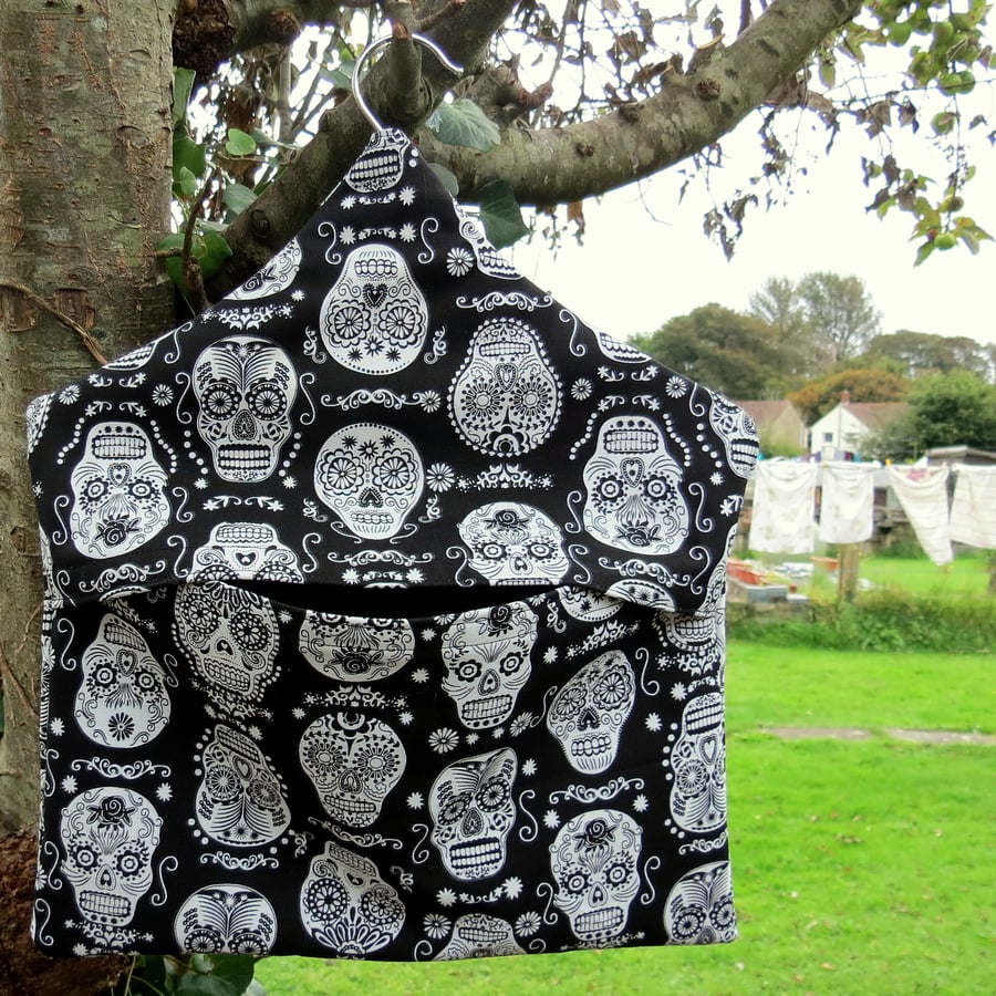 A peg bag with a skulls design.  Laundry.